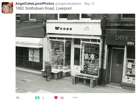 Image of a tweet showing a shop in the 80s in Liverpool. A woman looks in the windows. The shop is named Woods.